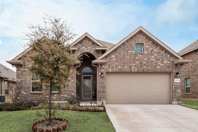 view of front facade featuring a front yard, brick siding, driveway, and an attached garage