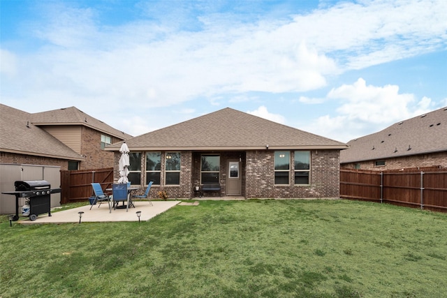 back of property featuring a patio area, brick siding, a lawn, and a fenced backyard