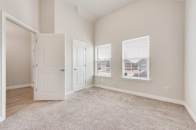 empty room featuring carpet and baseboards