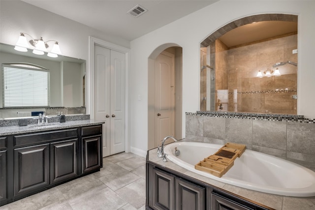 bathroom featuring tile patterned flooring, a garden tub, vanity, visible vents, and a shower stall