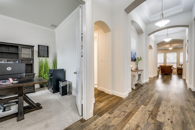 office area featuring baseboards, hardwood / wood-style floors, visible vents, and crown molding