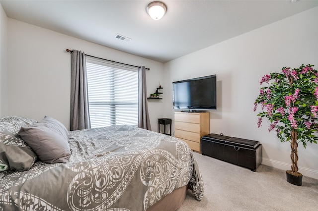 carpeted bedroom featuring visible vents and baseboards