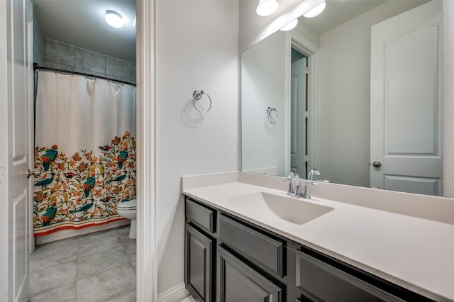 bathroom featuring toilet, curtained shower, vanity, and tile patterned floors