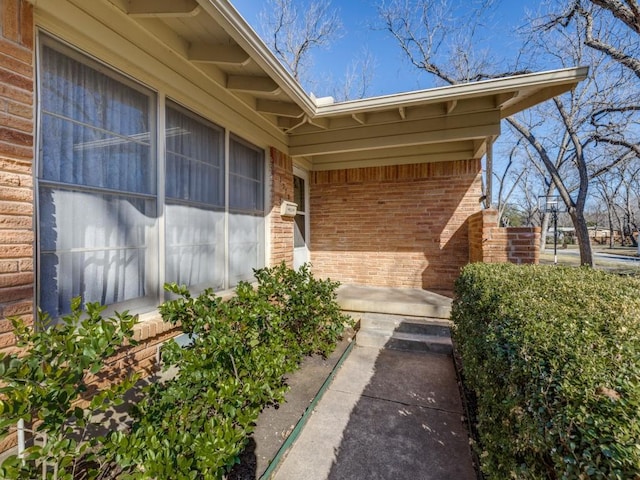 property entrance featuring brick siding