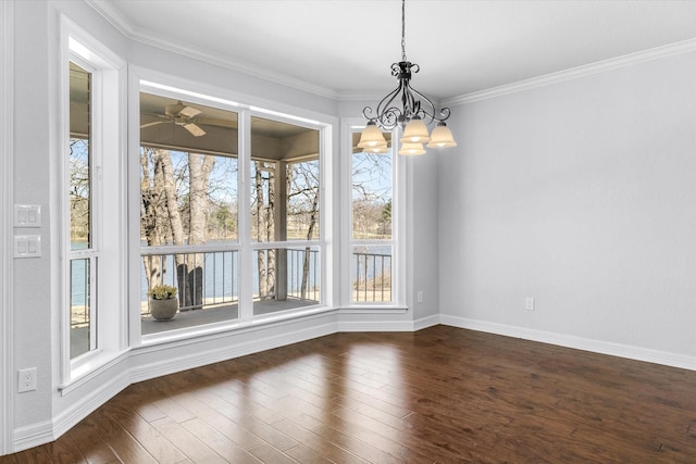 unfurnished dining area with a healthy amount of sunlight, baseboards, ornamental molding, and dark wood-style flooring