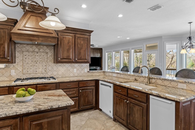 kitchen featuring white appliances, a sink, visible vents, and crown molding