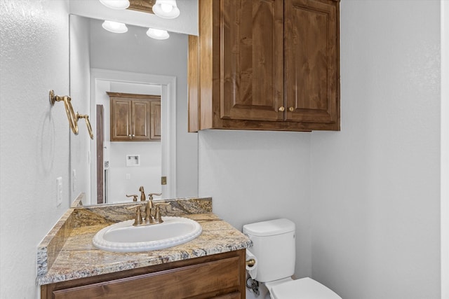 bathroom with toilet and vanity