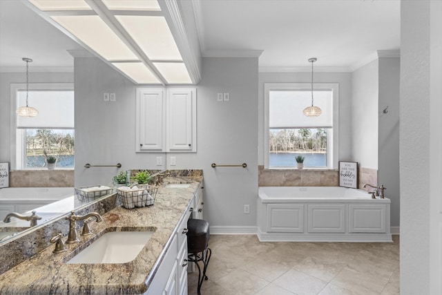 full bathroom with a bath, a wealth of natural light, ornamental molding, and a sink