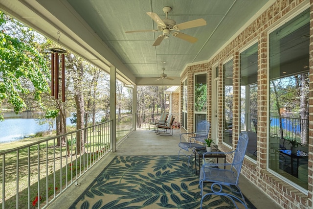 view of patio featuring a porch, a water view, and ceiling fan