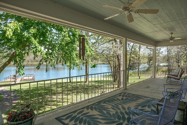 sunroom featuring a water view and wood ceiling