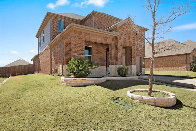 exterior space with a yard, brick siding, and fence