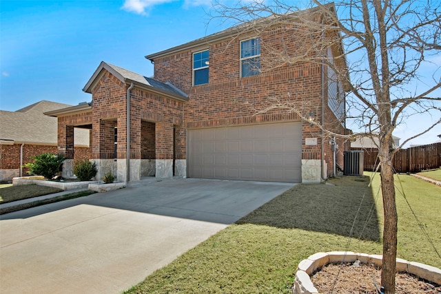 traditional home with a garage, concrete driveway, fence, a front lawn, and brick siding