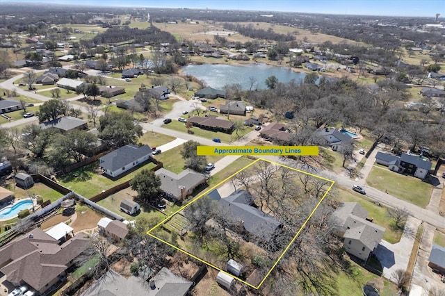 drone / aerial view featuring a water view and a residential view