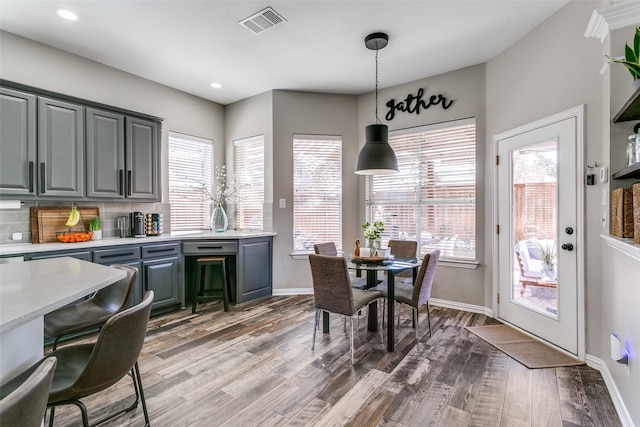 kitchen featuring plenty of natural light, visible vents, light countertops, and wood finished floors