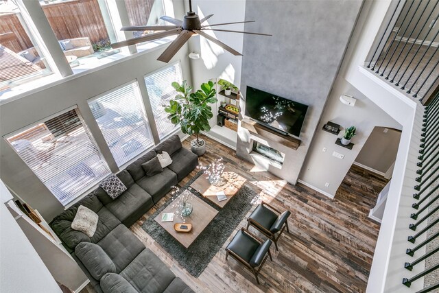 905 Water Oak Dr, Grapevine, TX 76051 - living area with wood finished floors, a ceiling fan, a high ceiling, baseboards, and stairway