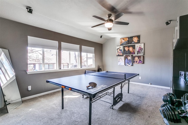 playroom featuring carpet, baseboards, vaulted ceiling, and a ceiling fan