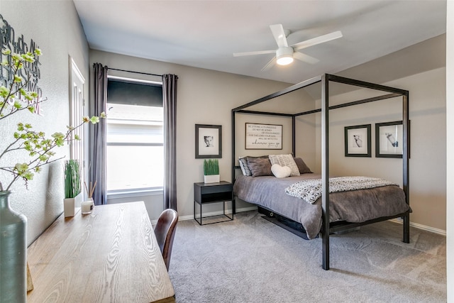 bedroom with a ceiling fan, carpet, and baseboards