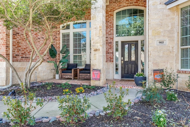 view of exterior entry with brick siding