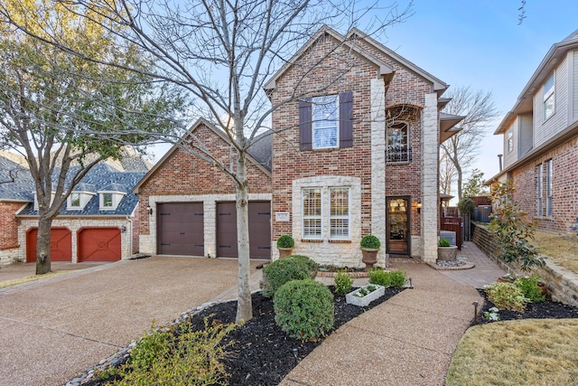 traditional home featuring brick siding, an attached garage, and driveway