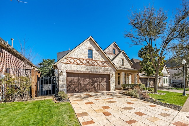 view of front facade with stone siding, an attached garage, driveway, and a front lawn