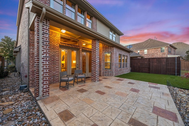 view of patio featuring french doors and fence