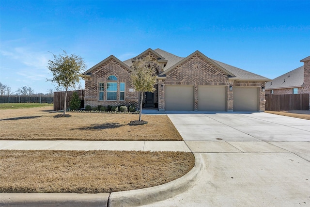 view of front facade with an attached garage, brick siding, a shingled roof, fence, and driveway