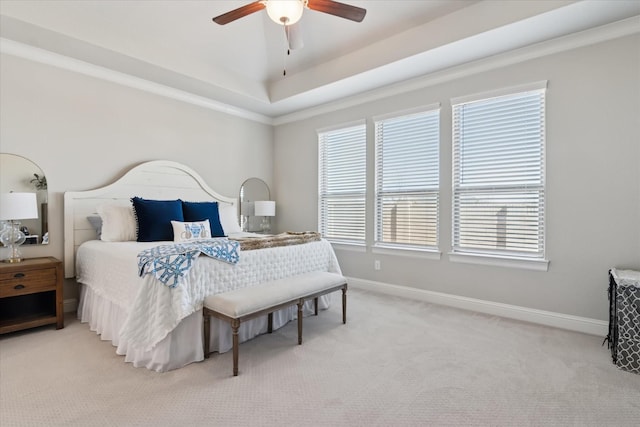 bedroom with light colored carpet, ceiling fan, and baseboards