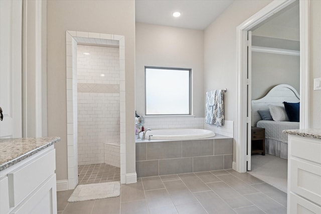 bathroom with a garden tub, ensuite bath, a walk in shower, and tile patterned floors