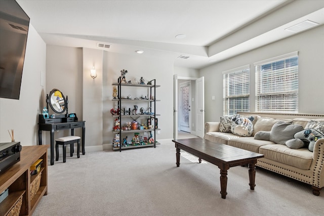 living room featuring baseboards, visible vents, and carpet flooring