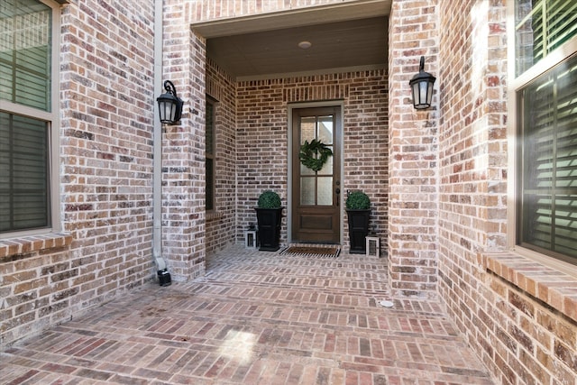 property entrance with brick siding