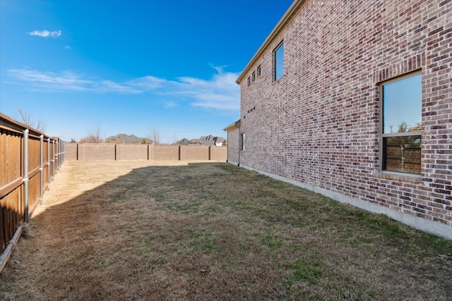 view of yard with a fenced backyard