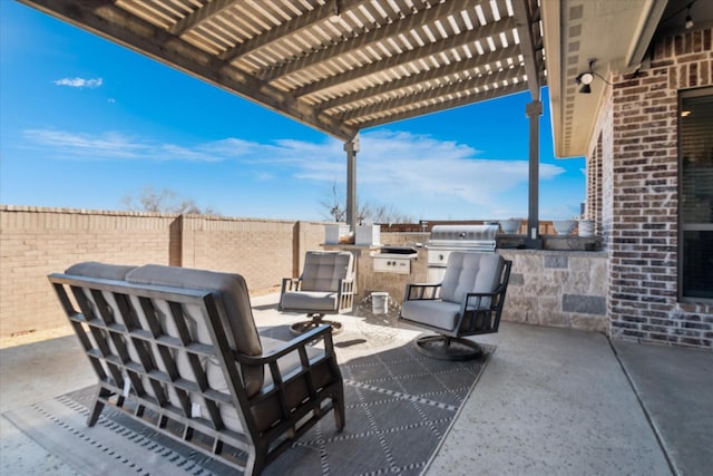 view of patio / terrace featuring exterior kitchen, fence, area for grilling, and a pergola