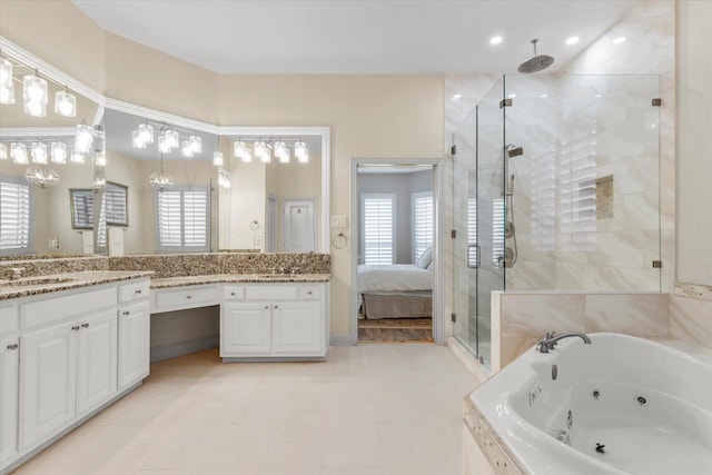 full bathroom with plenty of natural light, a stall shower, a jetted tub, and vanity