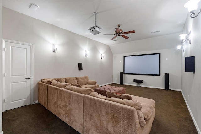 home theater room featuring vaulted ceiling, a ceiling fan, baseboards, and dark carpet