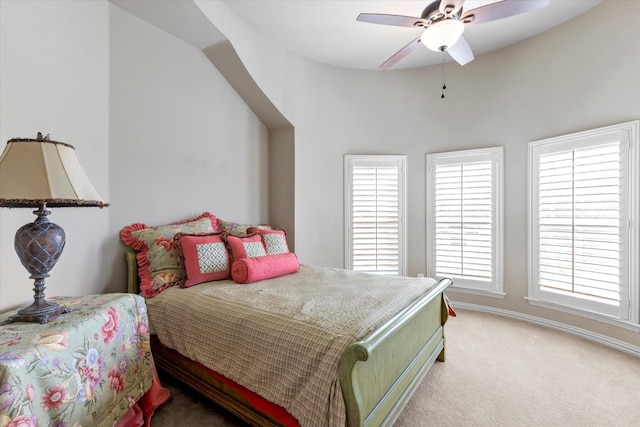 bedroom featuring a ceiling fan, baseboards, and light carpet