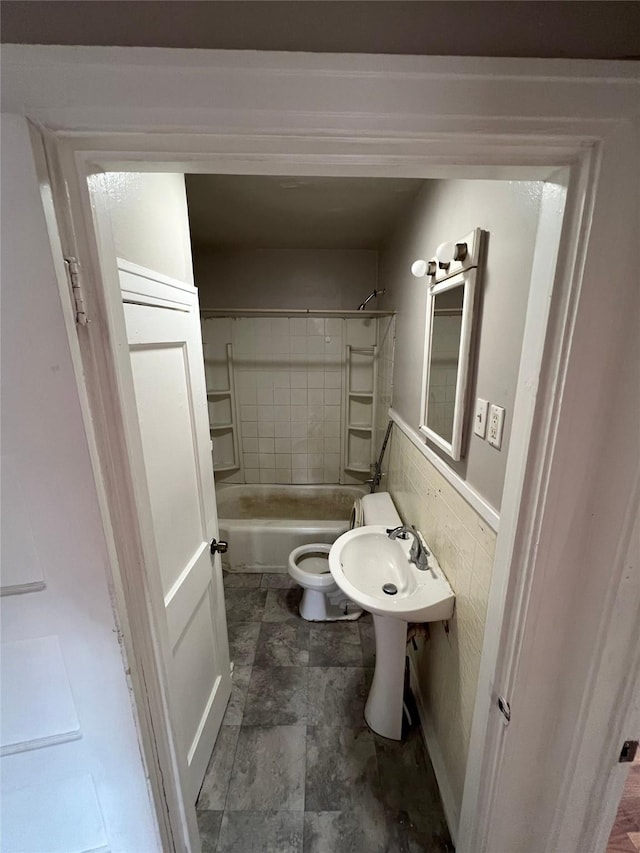 full bath featuring shower / bath combination, a sink, and toilet