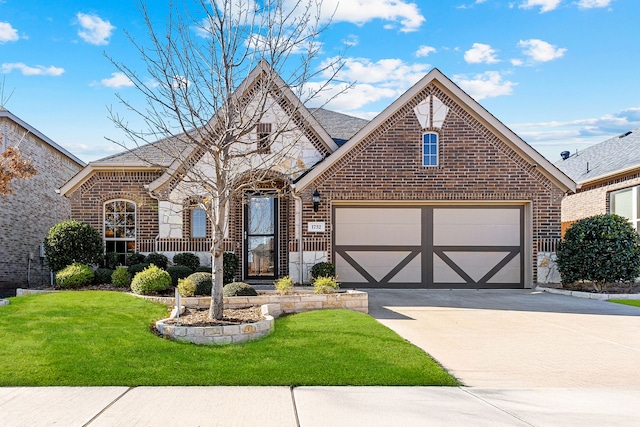 view of front of home featuring stone siding, a front lawn, concrete driveway, and brick siding