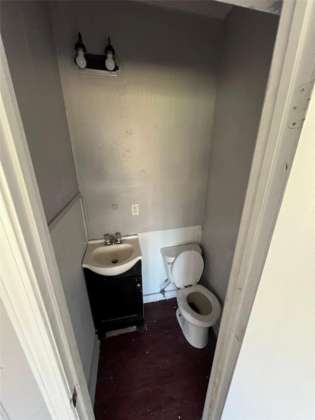 bathroom featuring toilet and vanity