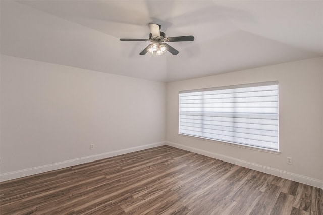 unfurnished room with dark wood-style floors, ceiling fan, baseboards, and vaulted ceiling