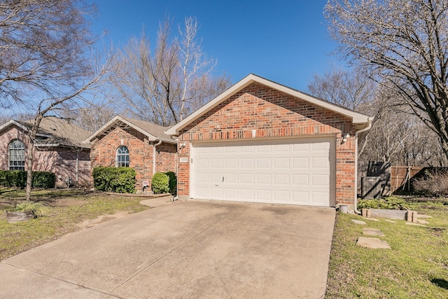 ranch-style house with a garage, driveway, and brick siding