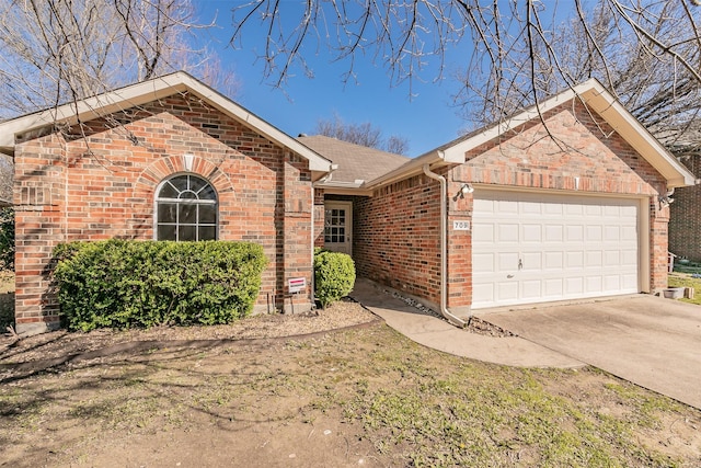 single story home with a garage, driveway, and brick siding