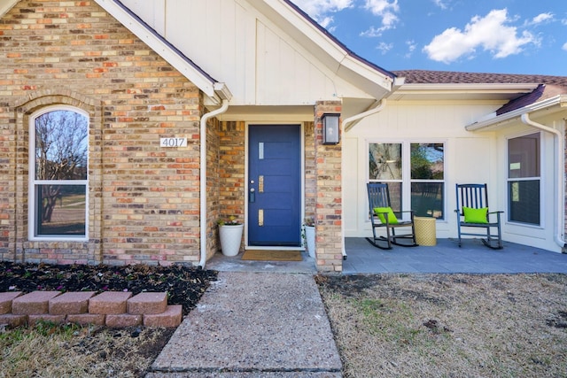 doorway to property with brick siding