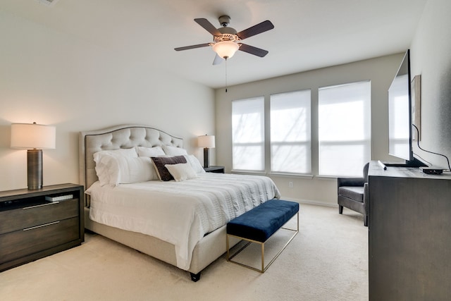 bedroom with light carpet, a ceiling fan, and baseboards