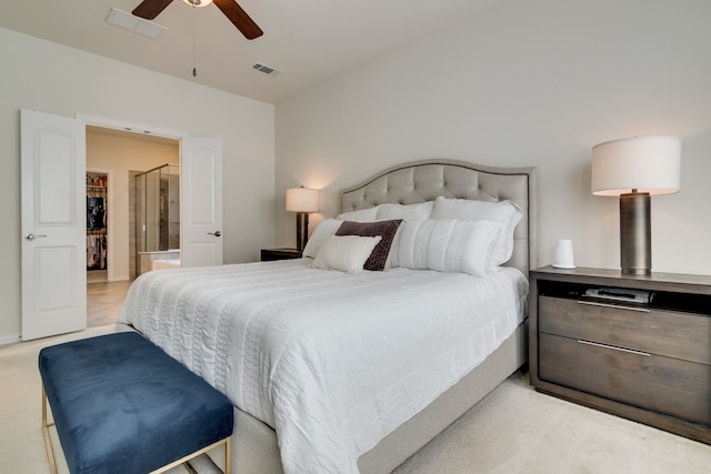 bedroom featuring carpet floors, a walk in closet, visible vents, and ceiling fan