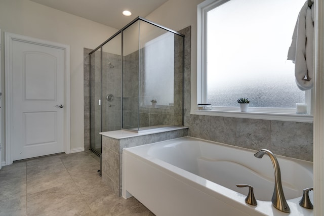 full bath featuring a stall shower, a bath, and tile patterned floors