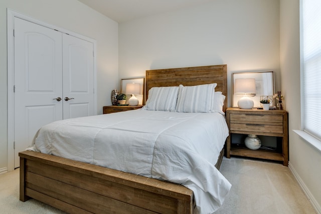 bedroom featuring carpet floors, a closet, and baseboards