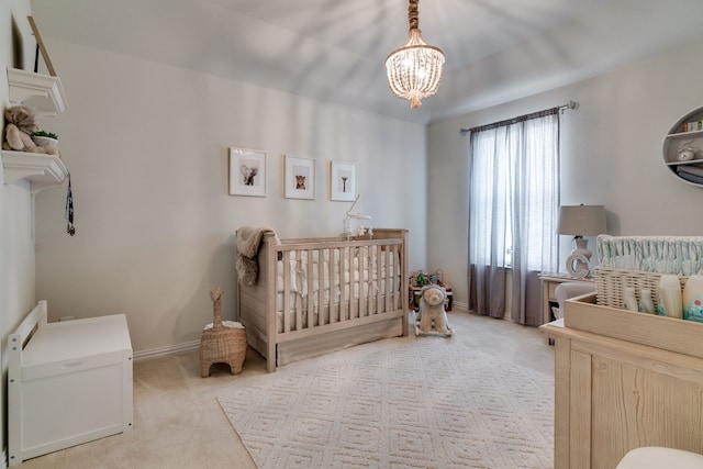 bedroom featuring a crib, carpet flooring, and baseboards