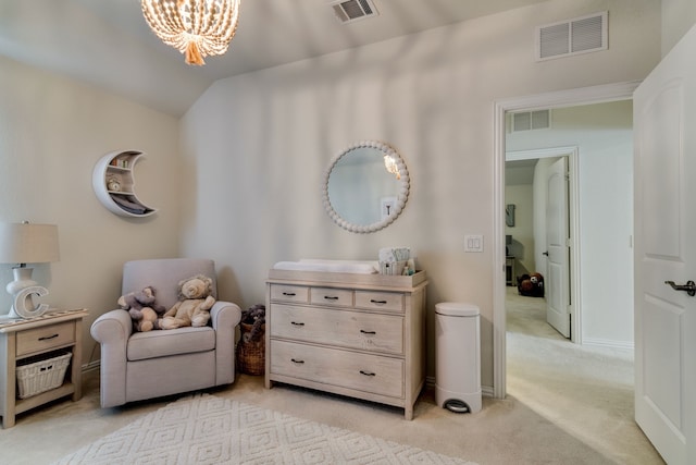 sitting room with an inviting chandelier, visible vents, and vaulted ceiling