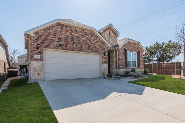 view of front of home featuring brick siding, fence, stone siding, driveway, and a front yard