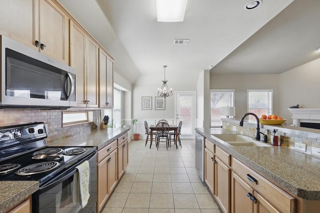 kitchen featuring light tile patterned floors, visible vents, light brown cabinetry, appliances with stainless steel finishes, and a sink